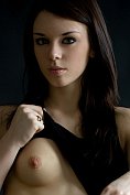 Serious girl strips off in the studio