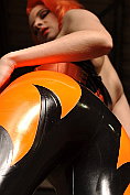 Ulorin shows off in her orange and black latex catsuit