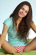 Irresistible nymph Rachelle is having a great time on the sofa bed flaunting her hairy pussy