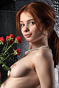 Pretty redhead Lily poses naked after taking off her little black dress