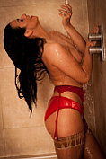 Epiphany gets in to the shower still wearing her knickers and her stockings and suspenders