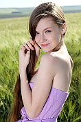 Pretty teen Emily takes off her dress in the fields